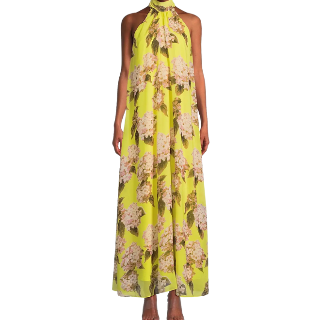 The model wears a yellow, floral-printed dress with a halter neck.  