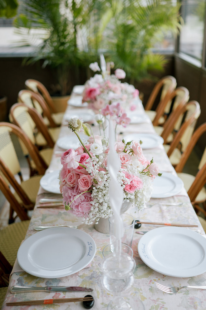Pink and white floral table centerpieces of reception table.