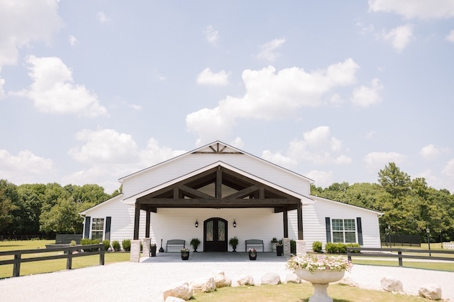 A white barn with wooden beams. 