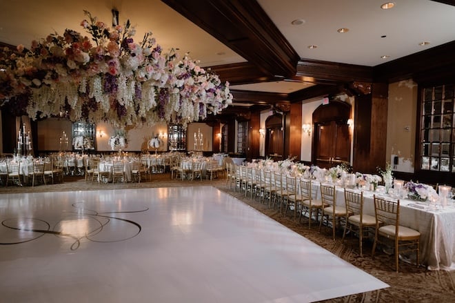 The ballroom at The Houstonian Hotel, Club and Spa is decorated in lavender and gold decor and white flowers.  