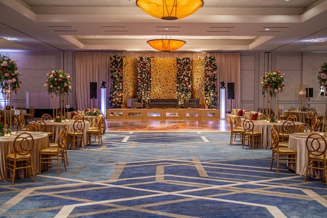 The ballroom at The Woodlands Waterway Marriott Hotel & Convention Center is decorated in red and pink roses.