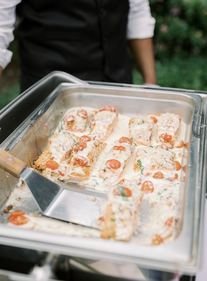 Café Natalie serves a buffet of salmon at an outdoor wedding reception in Houston. 