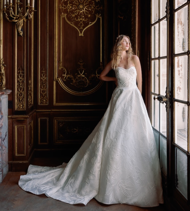 A strapless wedding gown with floral embellishments. 