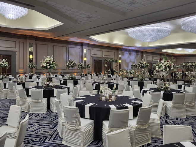 The ballroom at the Hilton Houston North is decorated in white roses and white decor.