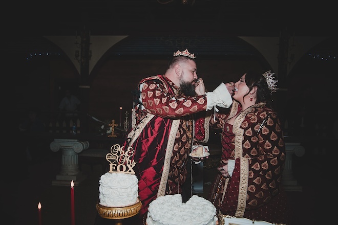 The bride and groom feeding each other wedding cake. 