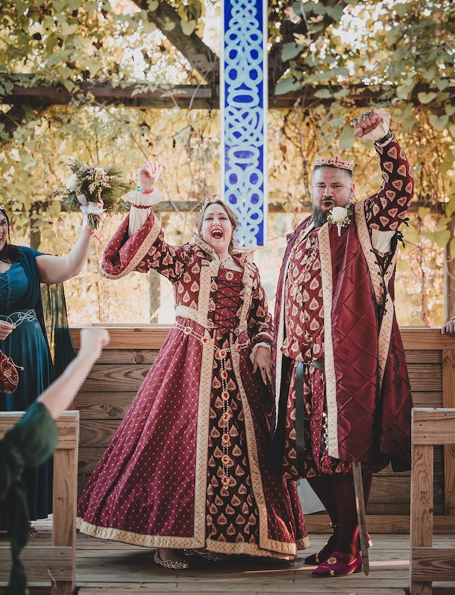 The bride and groom cheering at the altar after the ceremony. 