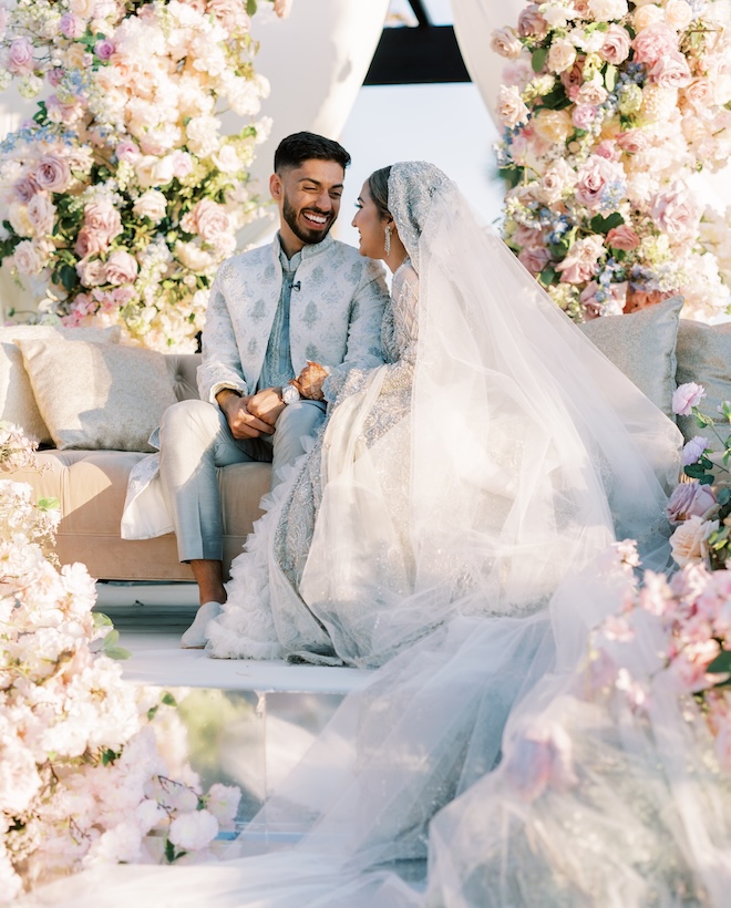 The bride and groom smile at each other during their outdoor ceremony at the Grand Galvez.