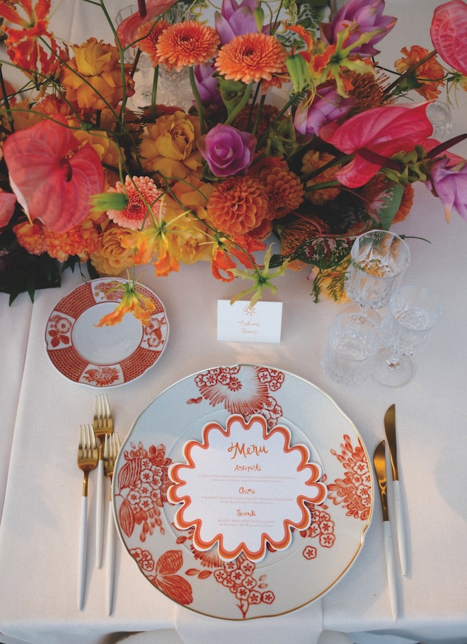 Orange table ware and stationery decorate the reception tables.