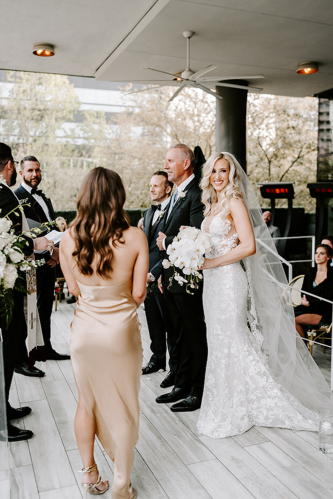 Father of the bride giving her away at the altar.