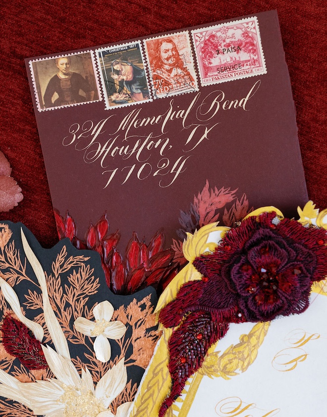 Red wedding invitations with gold accents. 