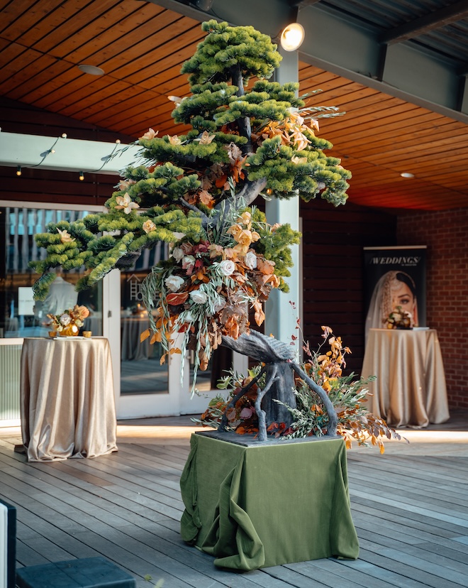 A bonsai tree decorated with autumn florals by Regina Gust Designs. 
