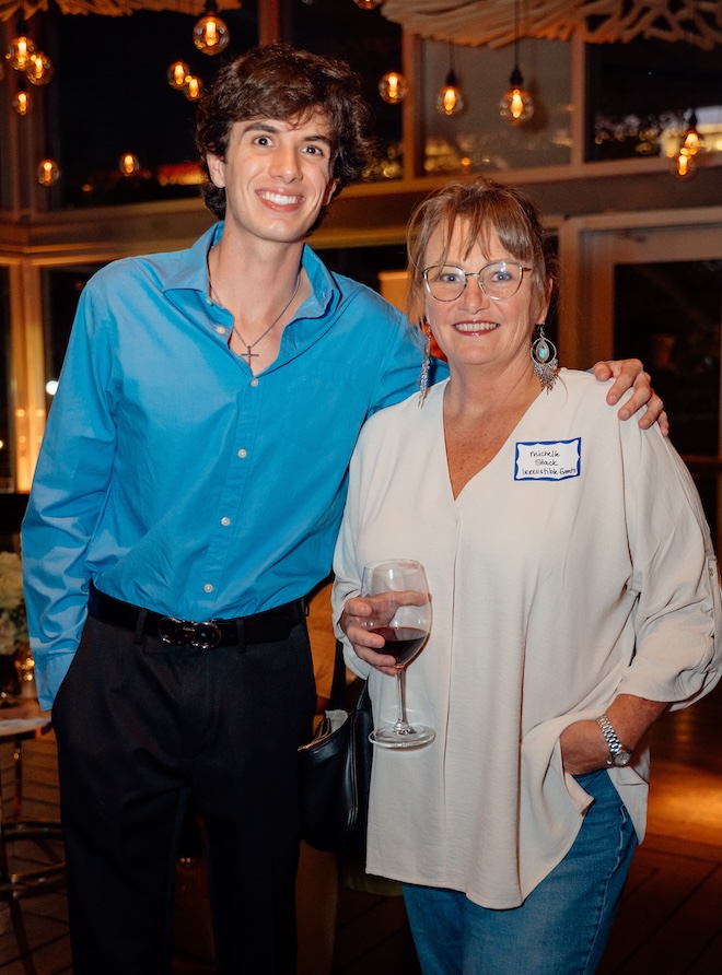 Guests posing for a photo at the Weddings in Houston client appreciation party.