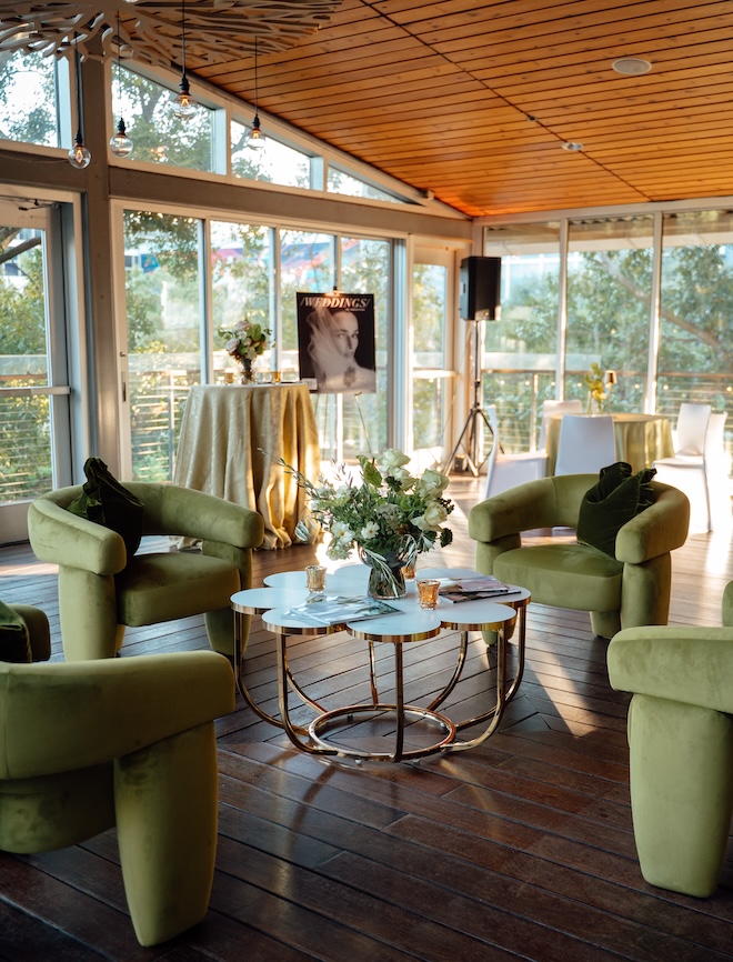 The inside of The Grove event area with green lounge seating and gold sparkly linens. 