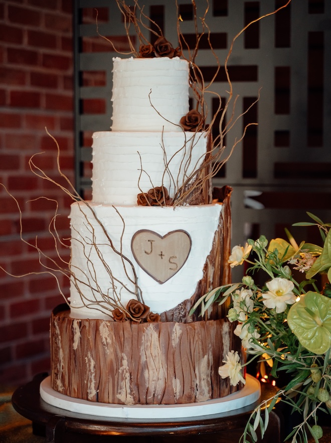 A three-tier cake with wooden details giving a treehouse vibe. 