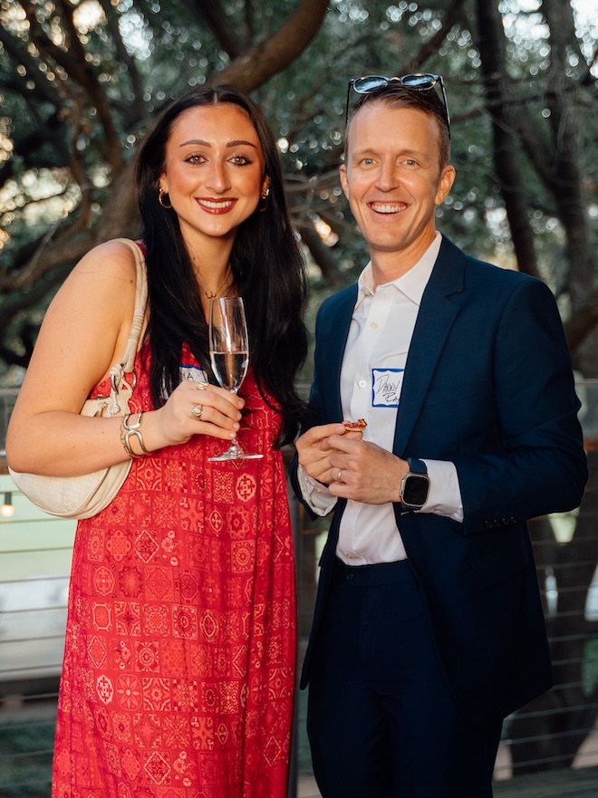 Guests posing for a photo at the Weddings in Houston client appreciation party.