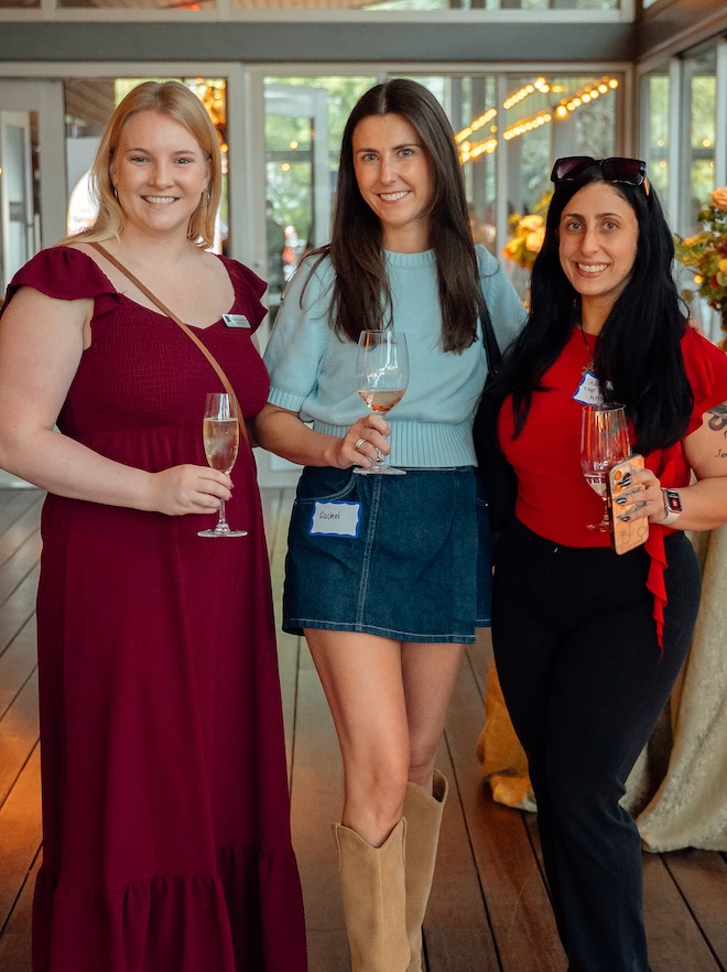 Guests posing for a photo at the Weddings in Houston client appreciation party.