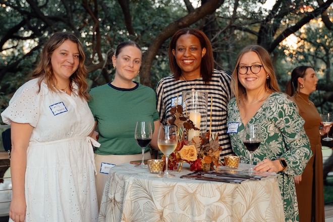 Guests posing for a photo at the Weddings in Houston client appreciation party.