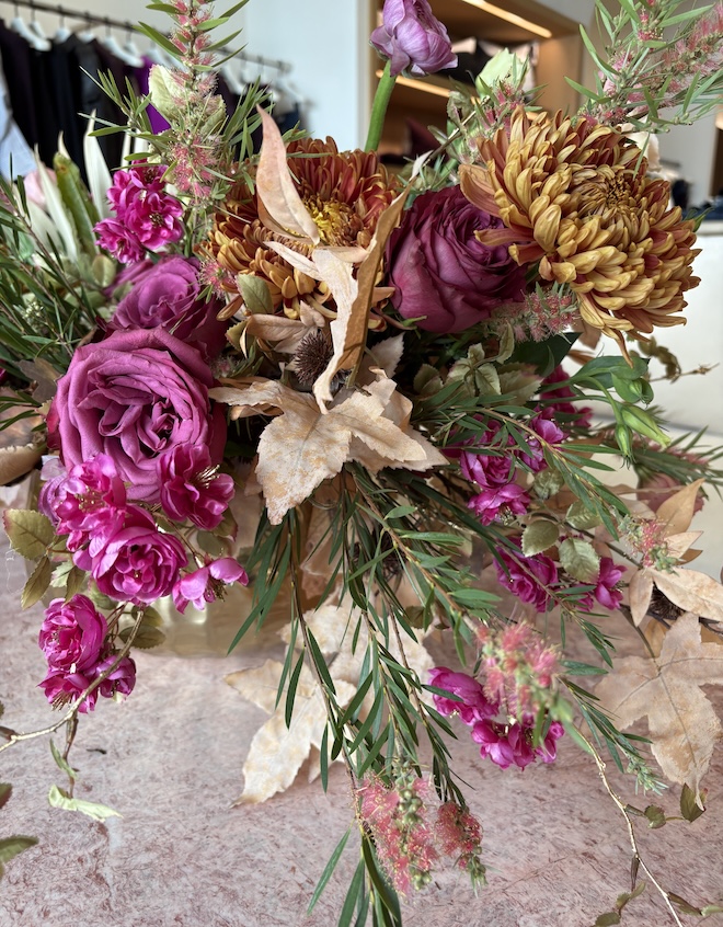A floral arrangement with purple and golden flowers.