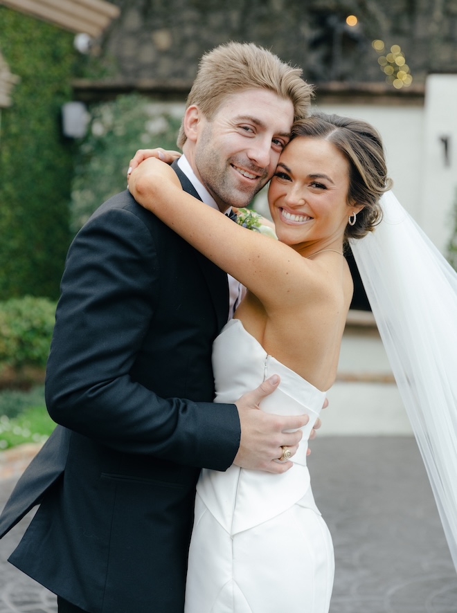 The bride and groom take portraits outside their wedding venue in Houston.