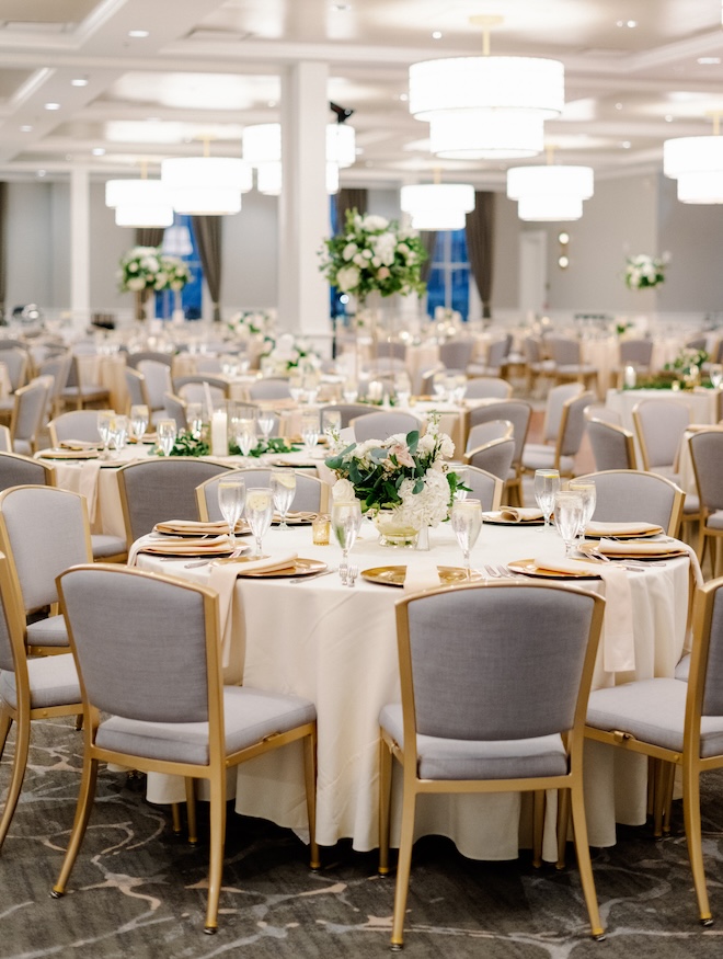 White flowers and pink pastel floral arrangements decorate the reception tables for the wedding at The Tremont House.