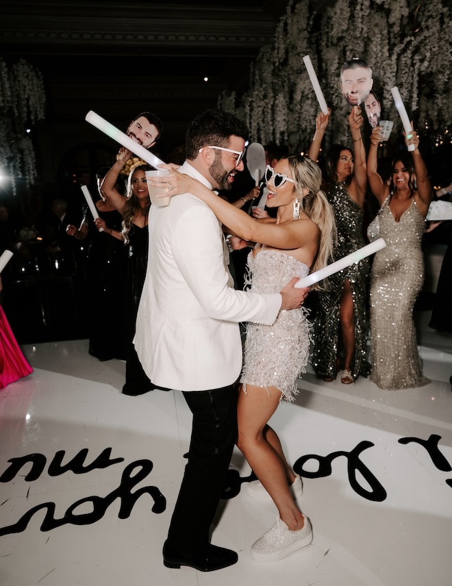 The couple dance on the dance floor at their wedding reception at Le Tesserae.