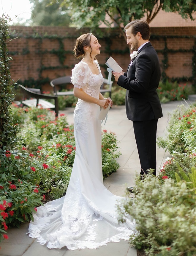 The bride and groom share private vows in the churches courtyard. 