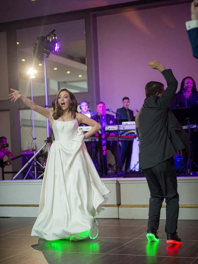 The bride and the father of the groom dance at the wedding reception.