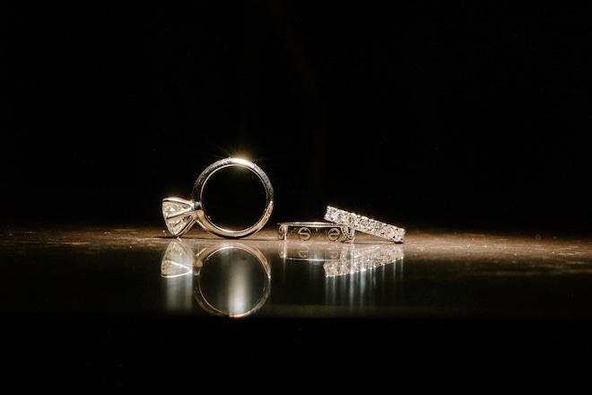 The couples rings shining in dark space.