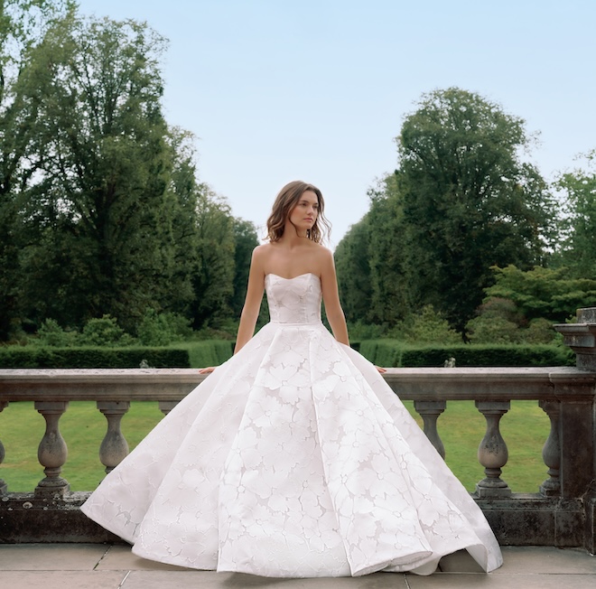 A bride wearing a Sareh Nouri jacquard ballgown with a modified sweetheart neckline. 
