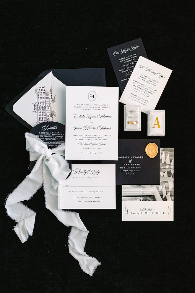 Black and white invitation layout with rings and white bow.