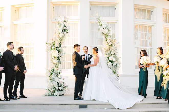 Bride and groom holding hands at the altar.