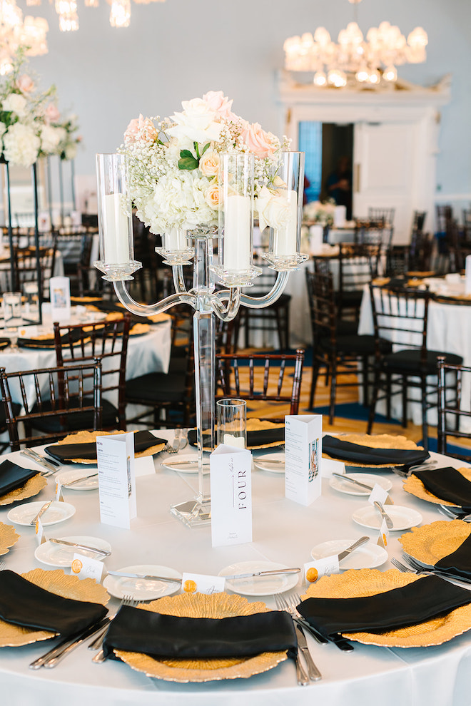 Black and white and emerald wedding reception table decor, with bouquet in the middle.