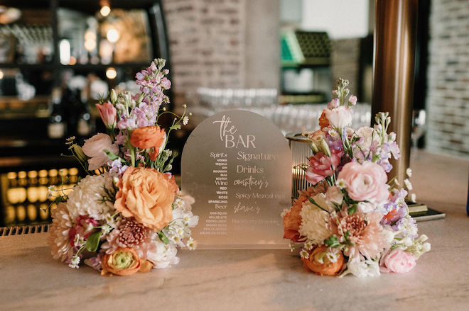Bar menu reading "the bar" with the same pastel florals around it.