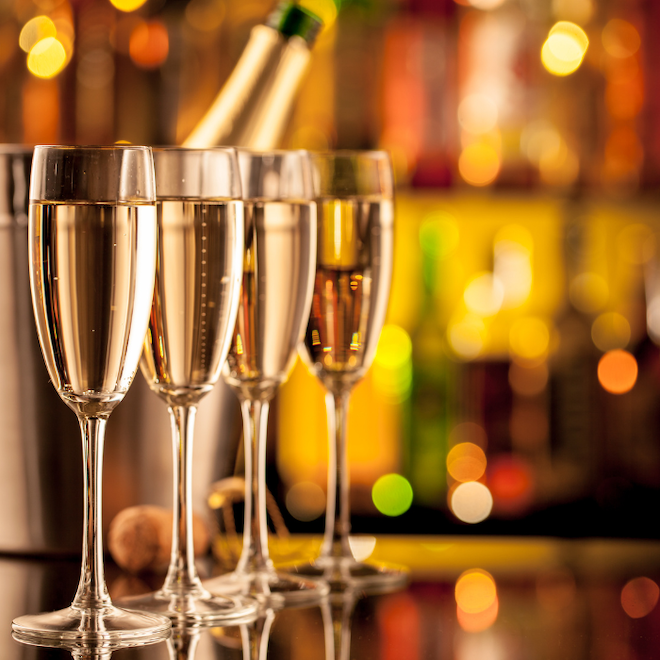 Four glasses of champagne lined up. 