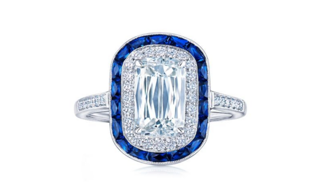 A diamond engagement ring with a sapphire halo.