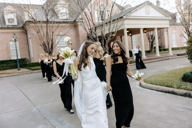 The bride walking with her bridesmaids. 