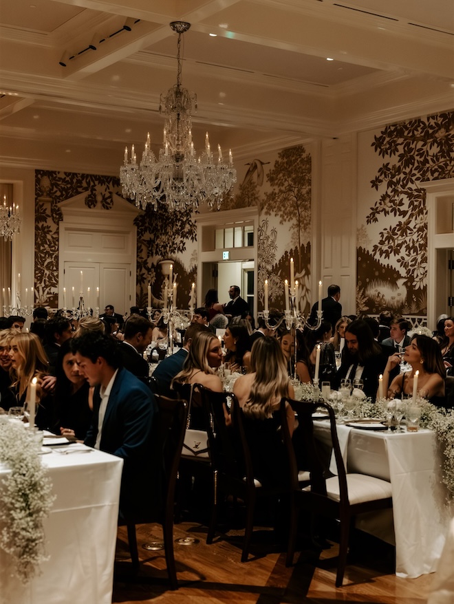 Wedding guests sitting at the reception tables.