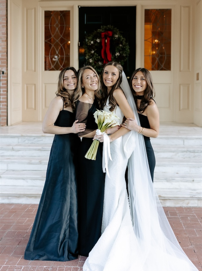 The bride posing with three bridesmaids.