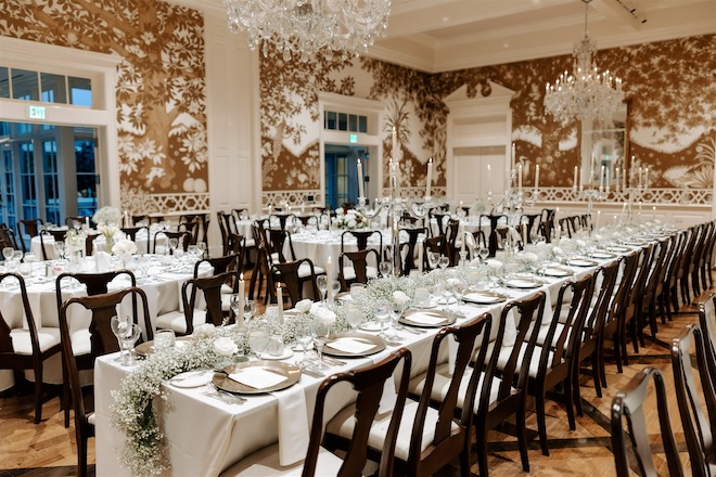 The reception tables decorated with white and black decor and baby's breath. 