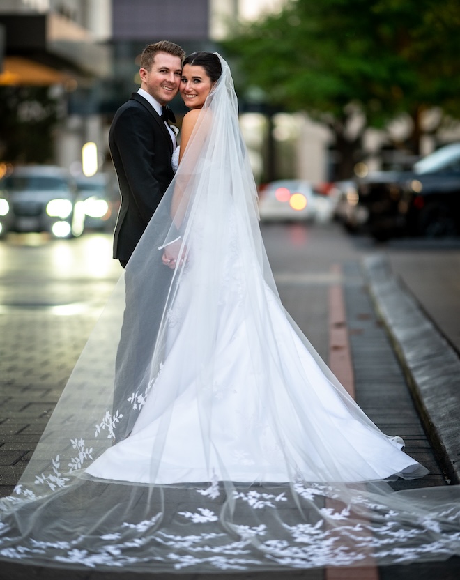 The bride and groom smiling outside the Post Oak Hotel at Uptown Houston. 