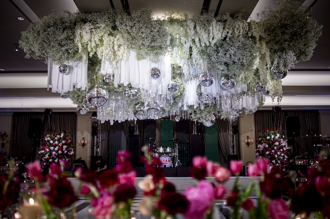A floral installation with disco balls over the dance floor for a New Year's Eve wedding. 