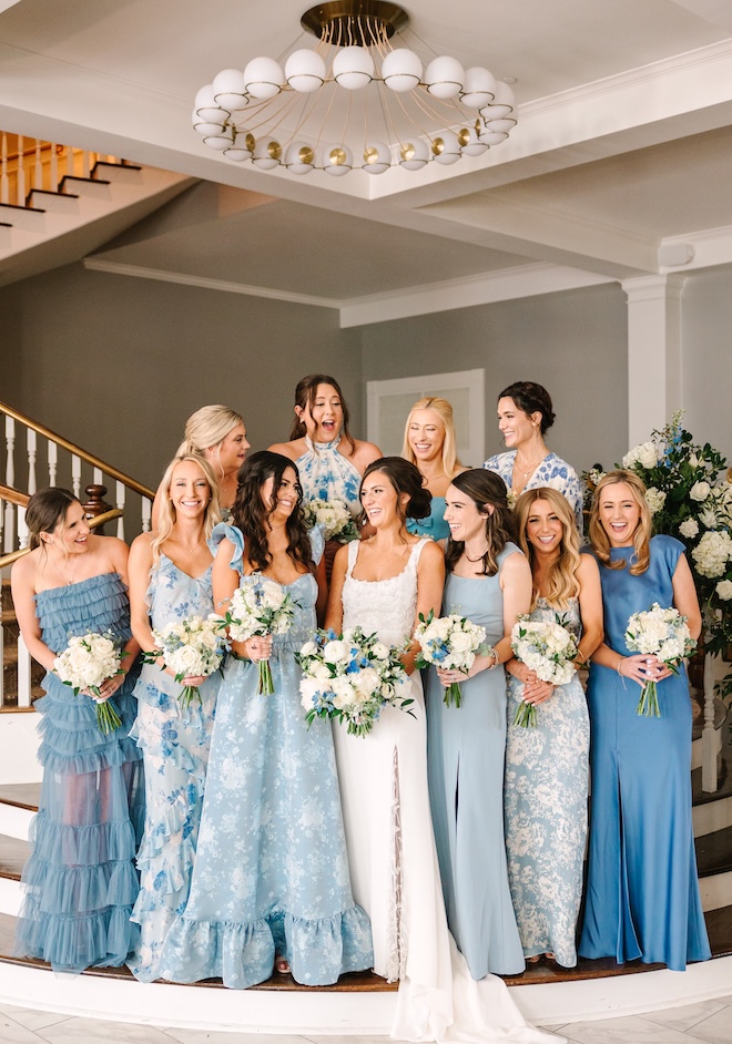 The bridesmaids wear blue mixed matched gowns for the wedding reception at The Tremont House for blue wedding inspiration.