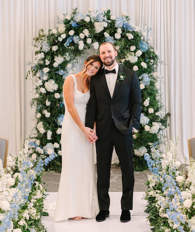 The bride smiling and resting her head on the groom's shoulder at their Tremont House wedding. 