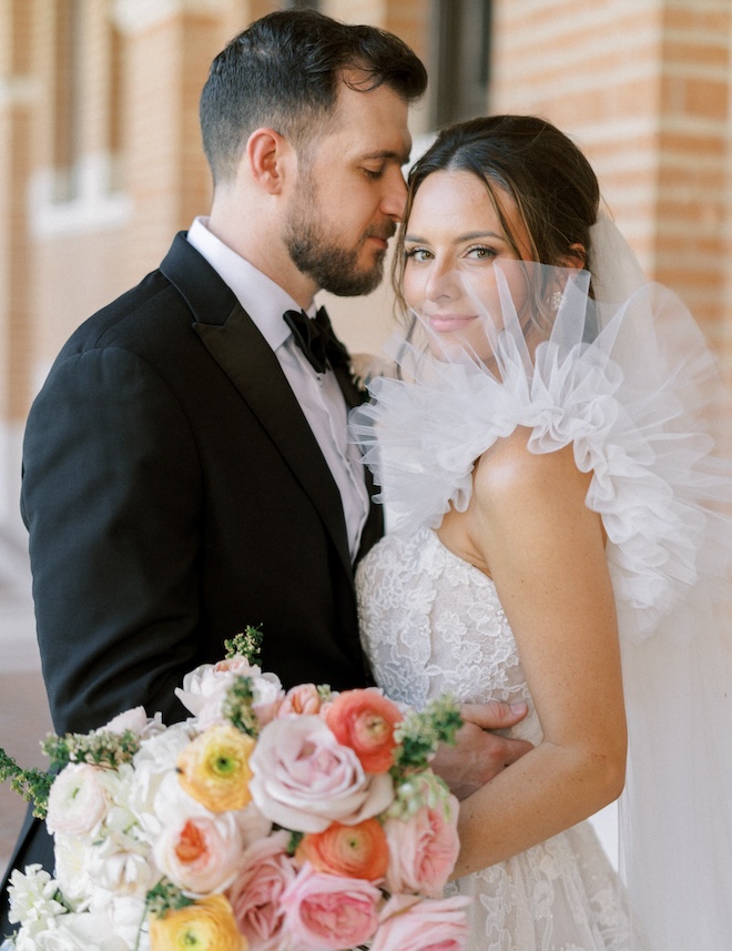 The bride and groom posing for a photo before their Petroleum Club reception. 