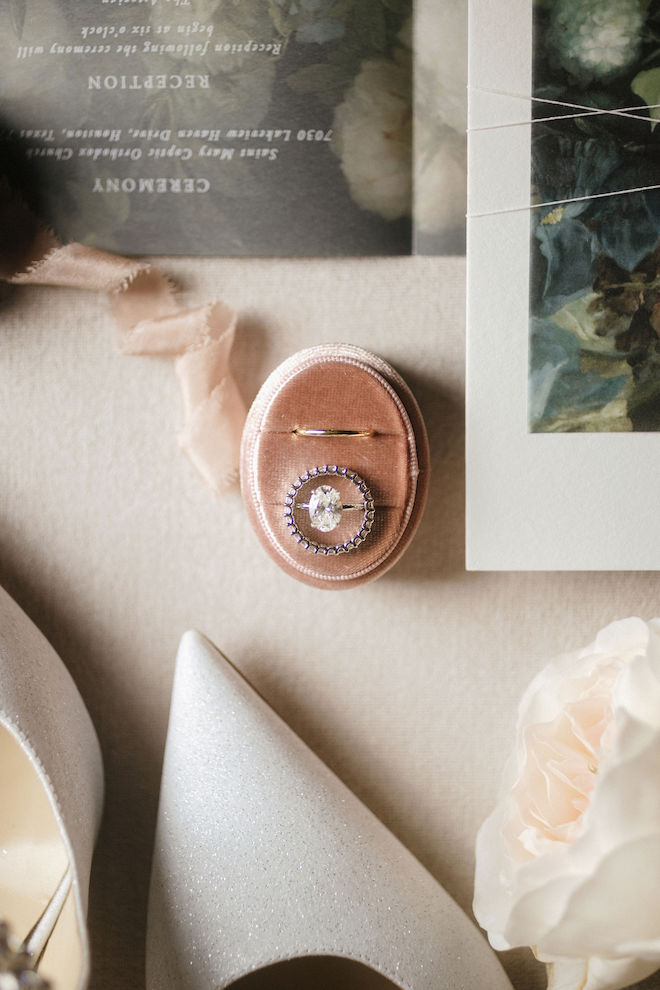 Close up of the diamond wedding ring and bands in rose gold velvet case.