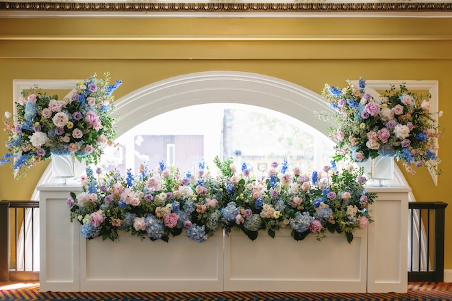 Pastel colored florals decorate the European countryside wedding ceremony at Hotel ICON. 