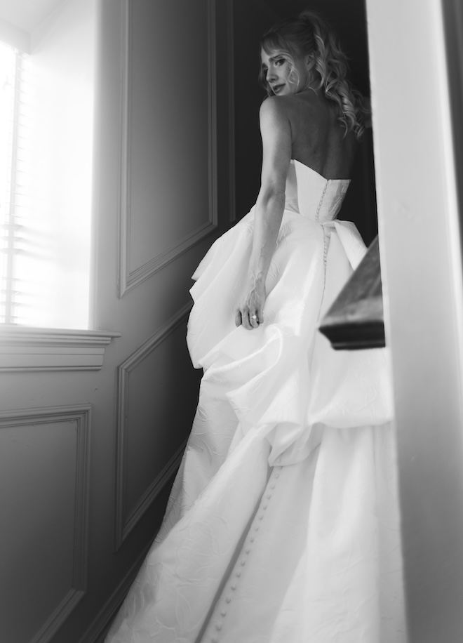 The bride walks up the stairs of the penthouse suite at Hotel ICON. 
