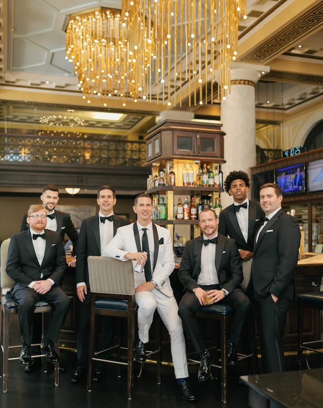 The groom and his groomsmen grab drinks in the bar of Hotel ICON. 