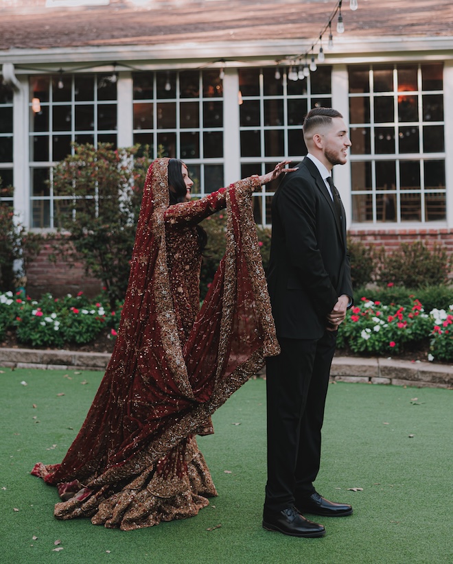 The bride tapping the groom's shoulder for their first look. 