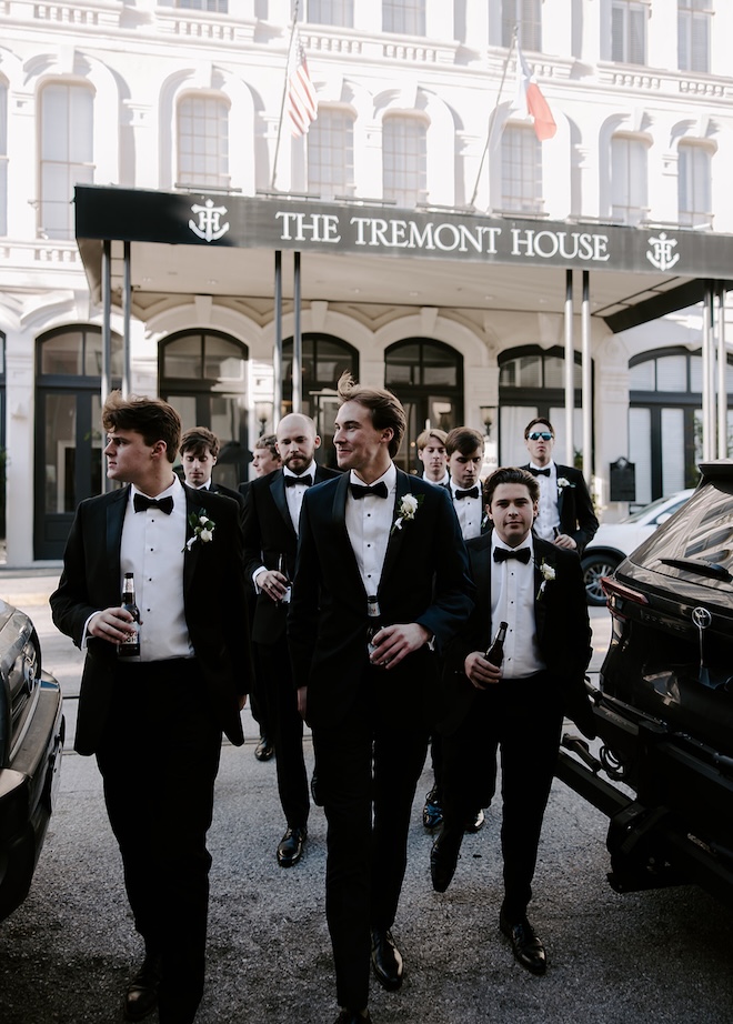 The groom and his groomsmen walk across the street from The Tremont House to the ballroom. 
